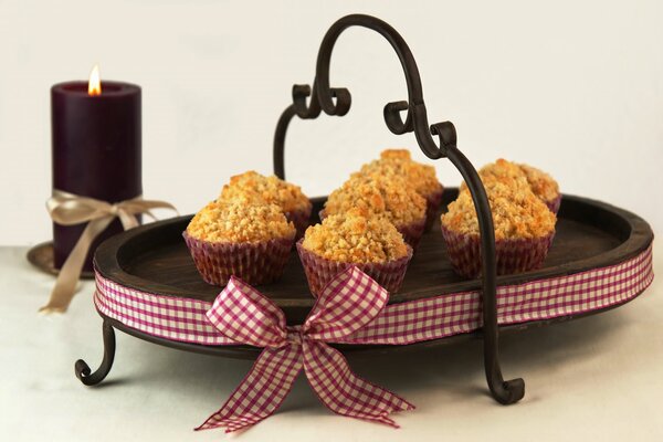 Muffins sur un plateau et une bougie sur une table