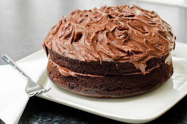 Schokoladenkuchen mit einer Kappe aus köstlicher Sahne