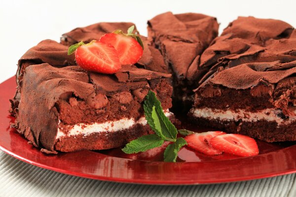 Chocolate cake with a layer and strawberries