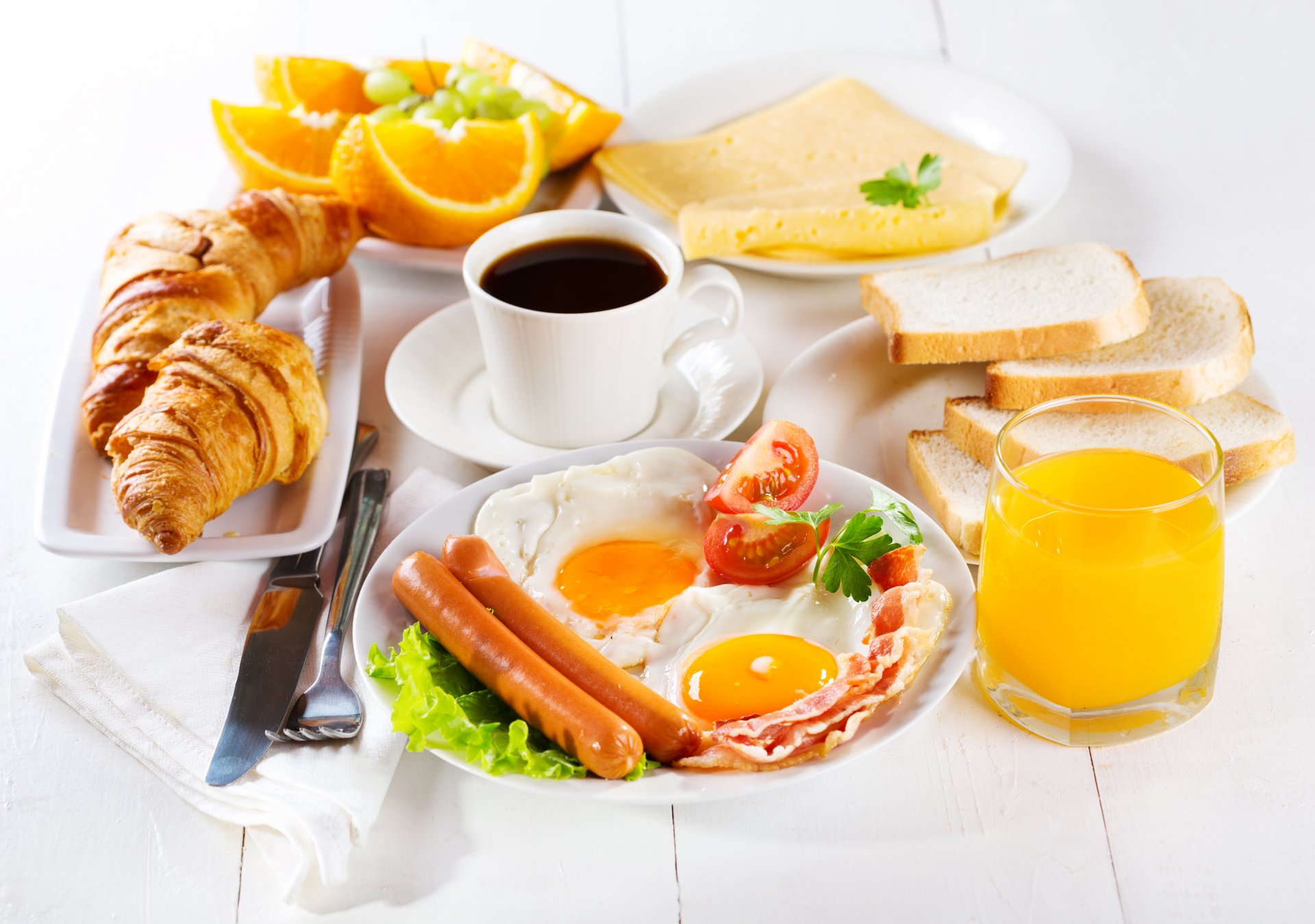 breakfast eggs bacon sausage tomatoes toast bread cheese juice orange bagels croissants coffee