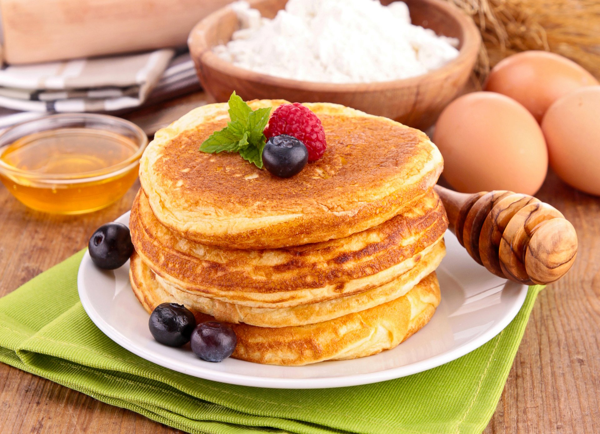 pancakes pancakes pancakes honey raspberries blueberries berries dishes spoon flour food