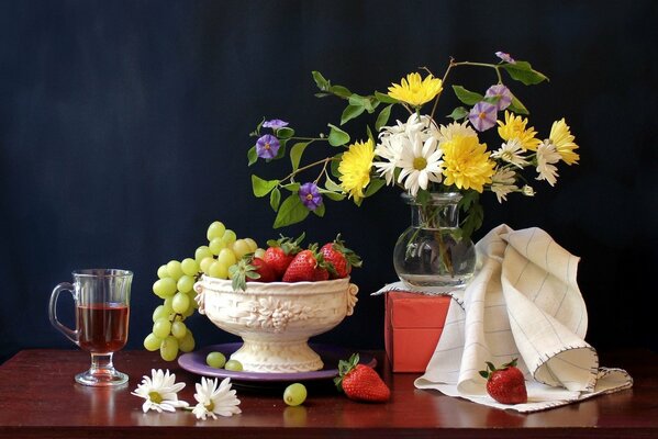 Still life with a vase of fruits and a bouquet