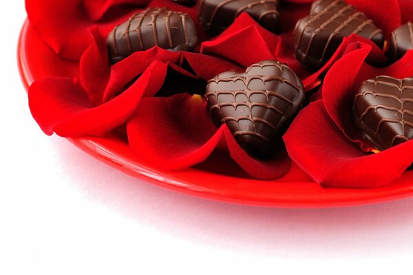 Heart-shaped chocolate candies on a red platter