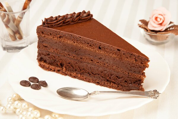 Chocolate cheesecake in a white plate with a spoon