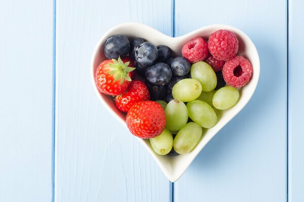 Different berries in a heart bowl