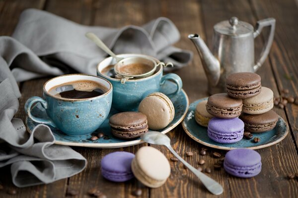 Beautiful wallpaper with two cups of coffee and delicate macaroons