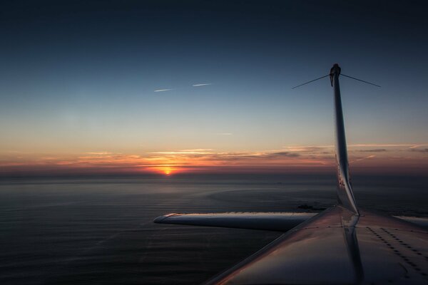 The plane flies over the clouds to the east