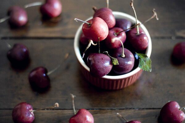 Cerezas maduras en un plato pequeño