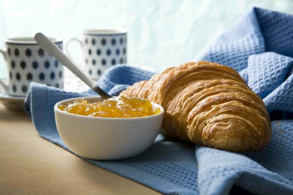 Colazione con croissant e spiedini dolci su un piatto di caffè