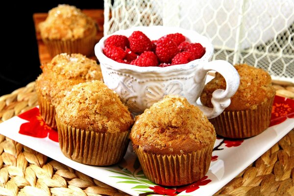 Bright juicy raspberries and cupcakes