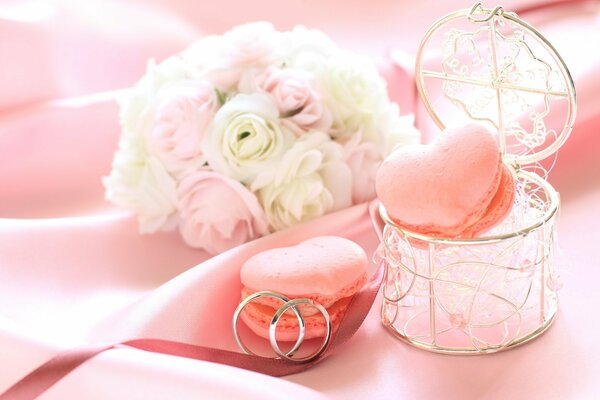 A box with flowers and cookies made of roses in the middle and a ring for your beloved