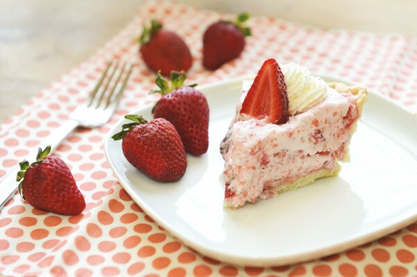 Delicious cake with cream and strawberries on a plate