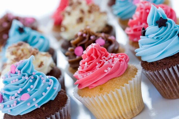 Sweet pastries decorated with cottage cheese cream and sprinkles