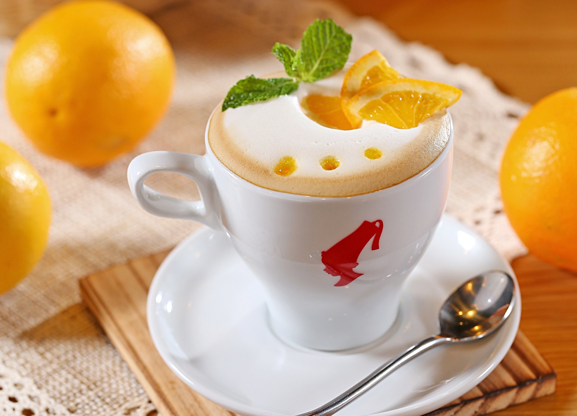 cappuccino milk coffee foam orange pieces fruits citrus cup white spoon saucer