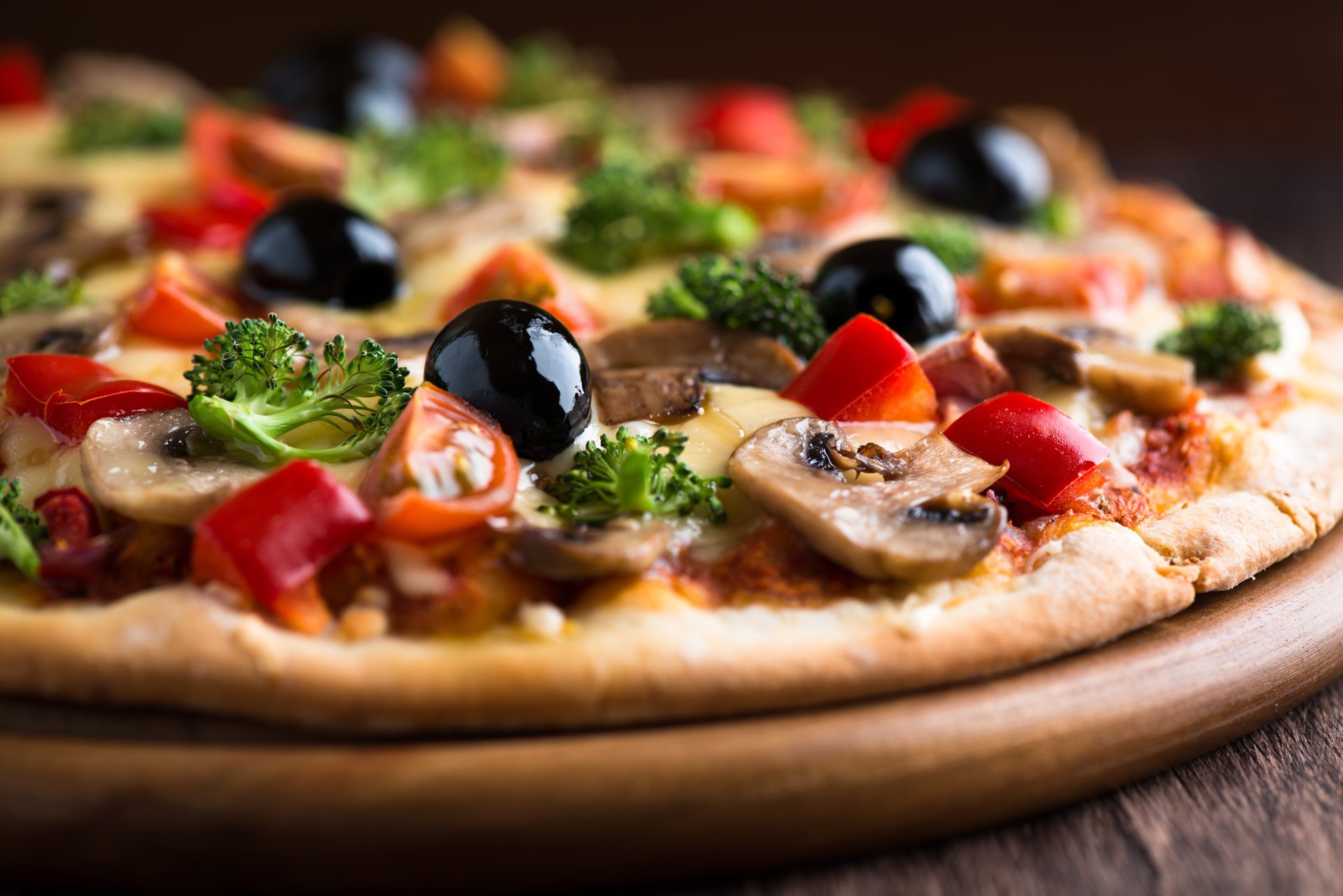 pizza olives cheese tomatoes mushrooms parsley dish