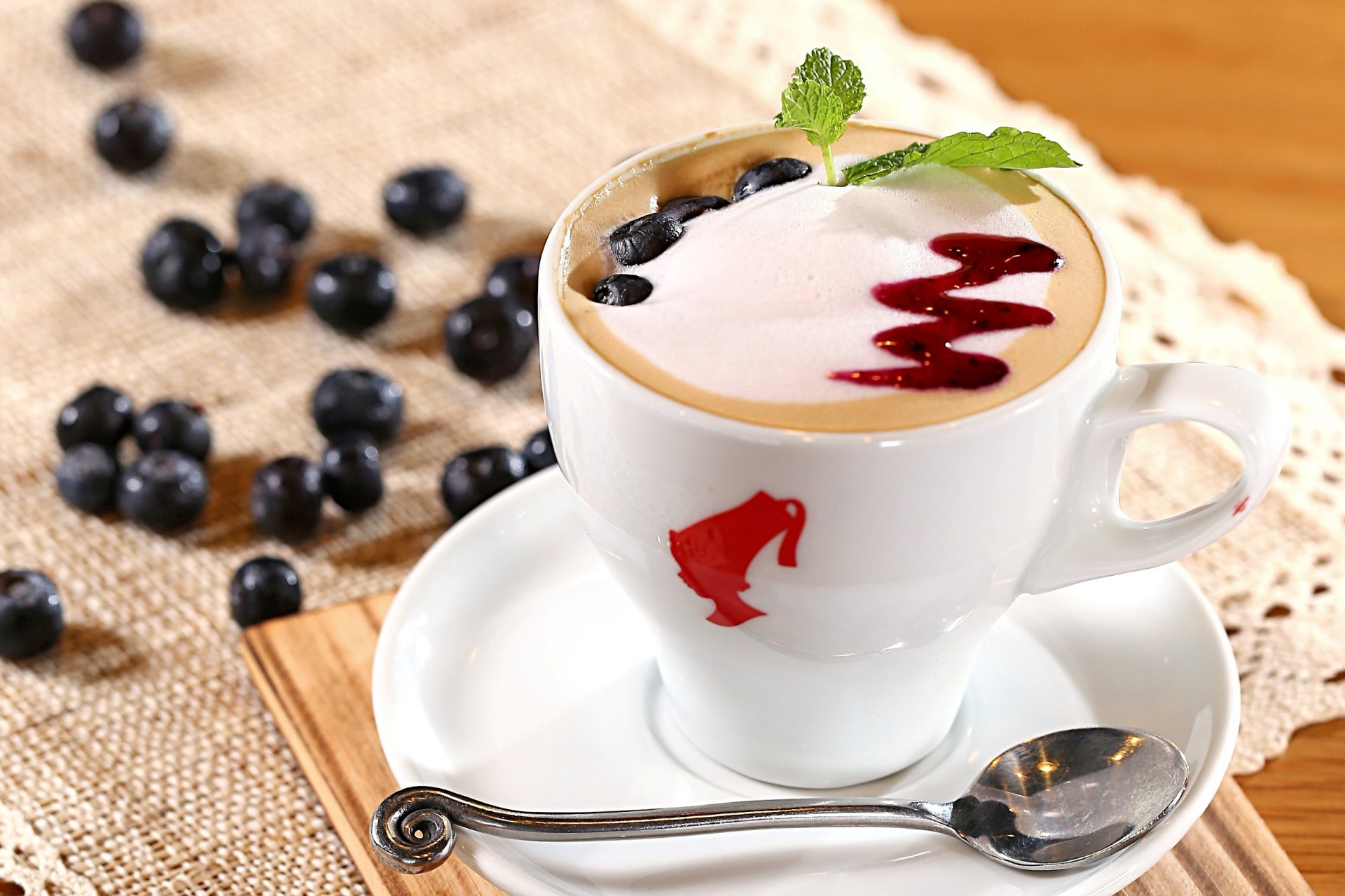 cappuccino coffee milk foam topping jam blueberries berries cup spoon saucer