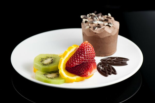 Dessert on a plate of ice cream and fruit