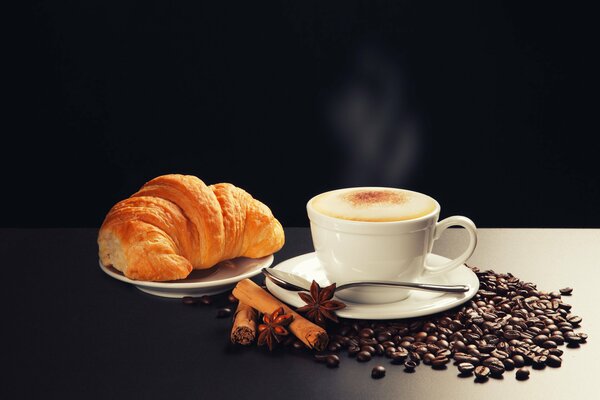 Fragrant cappuccino with cinnamon and croissant