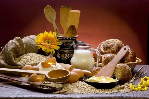 A table loaded with a plate, spoons and food