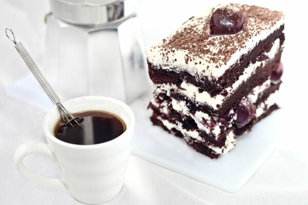 A cup of coffee and a chocolate cake