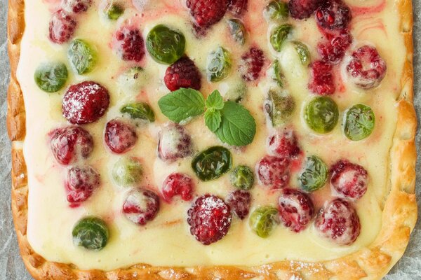 Dessert decorated with raspberries and mint leaves