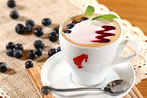 Cappuccino with airy foam and fresh blueberries