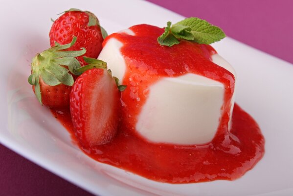 White dessert poured with strawberry syrup