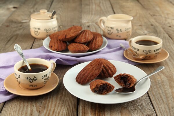 Caffè in tazze con biscotti Madeleine