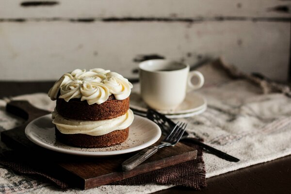 Sponge cake with cream and a cup of coffee