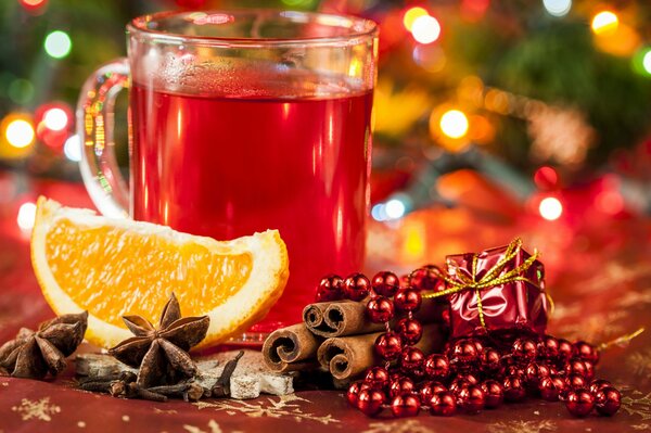 Mulled wine on a New Year s background with a juicy orange