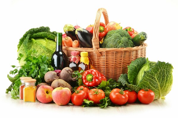 A basket of vegetables and a bottle of wine