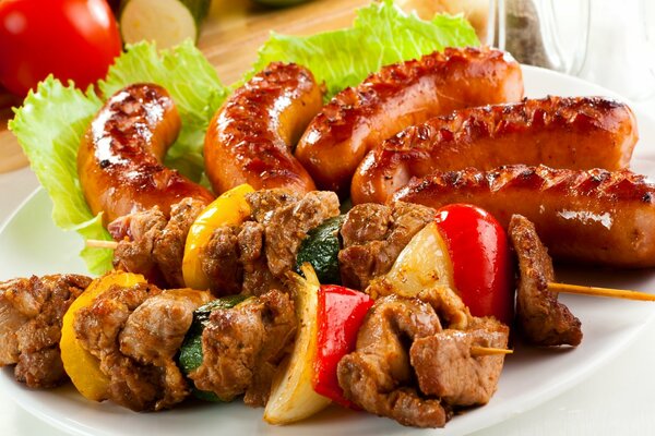 Shish kebab on a joint with pomilor, cucumber and sausages