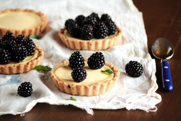 Tartlets with blackberries are a beautiful composition on the table