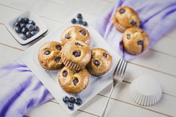 Muffins de arándanos en un plato con un tenedor