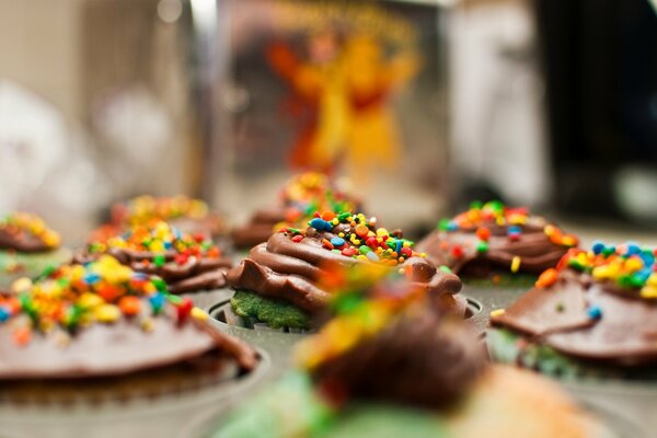 Cupcake tops decorated with chocolate cream and multicolored sprinkles