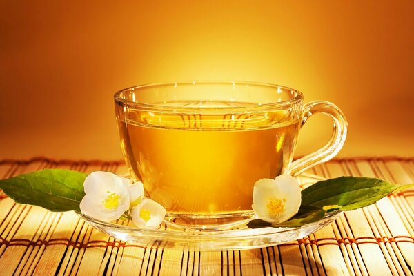 A cup of tea with jasmine on a saucer