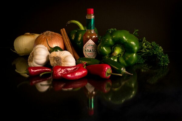 Still life on a black background with vegetables