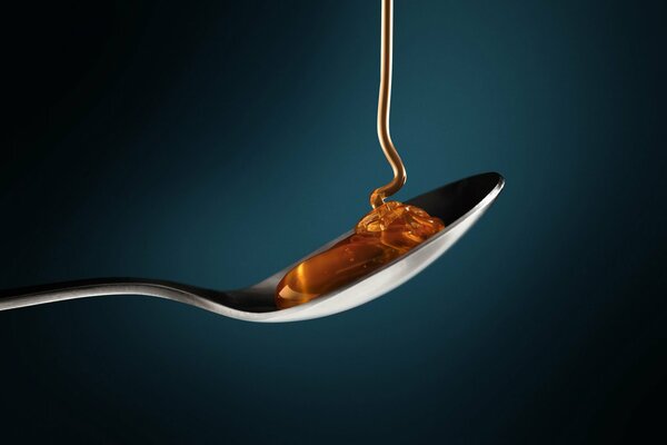 Macro photo of a spoon with honey