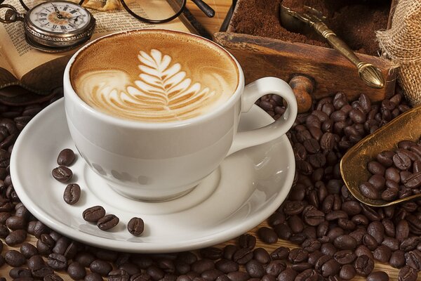 Cappuccino on the background of books and coffee beans