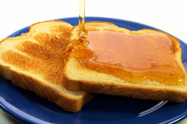 Toast with honey on a blue plate