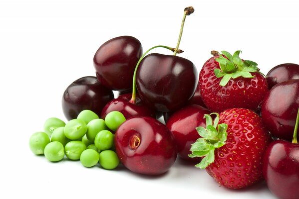 Red strawberries with juicy cherries and a handful of peas