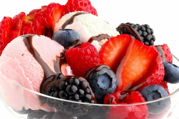 Ice cream with berries and syrup in a cream bowl