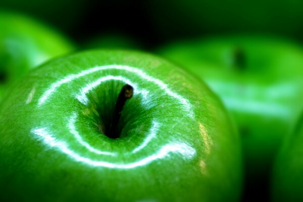 A green apple on a blurry background