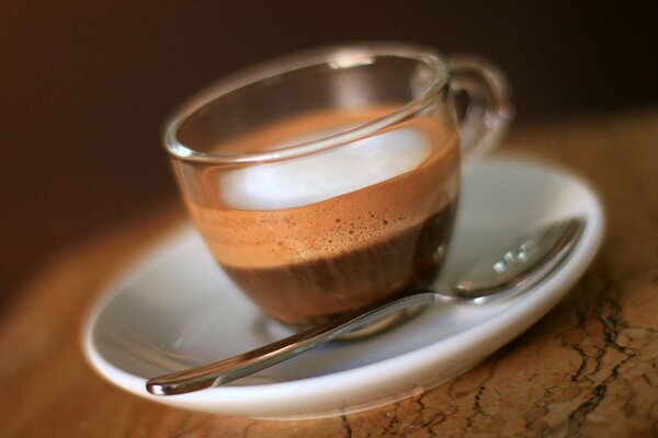 Fragrant coffee with foam in a transparent cup