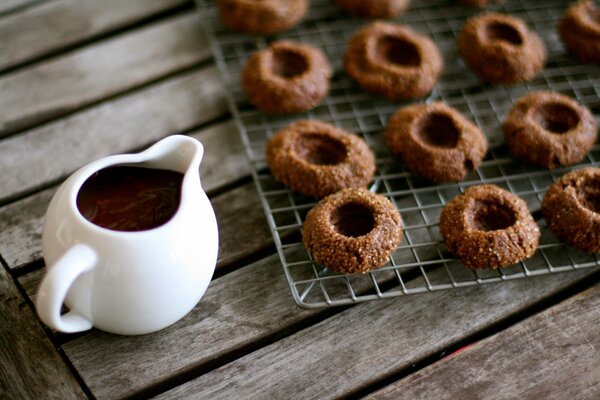 Biscuit cookies with a jug of chocolate