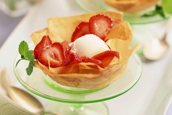 There is a dessert on a transparent saucer