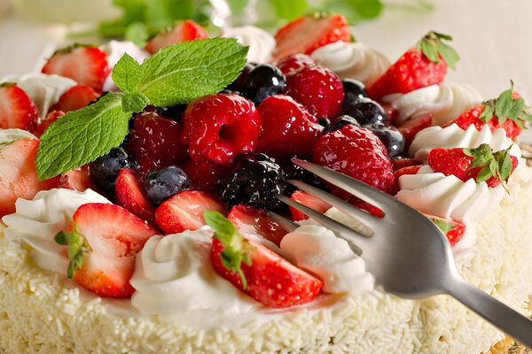 Birthday cake with whipped cream and berries