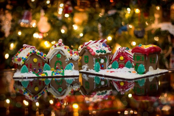 Gingerbread houses on the background of a Christmas tree and garlands