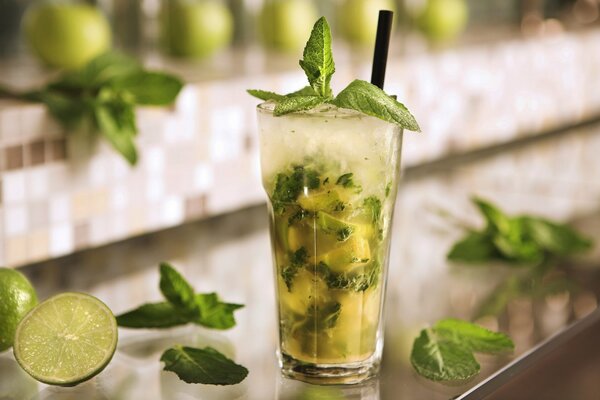 A glass with a mint lemon cocktail