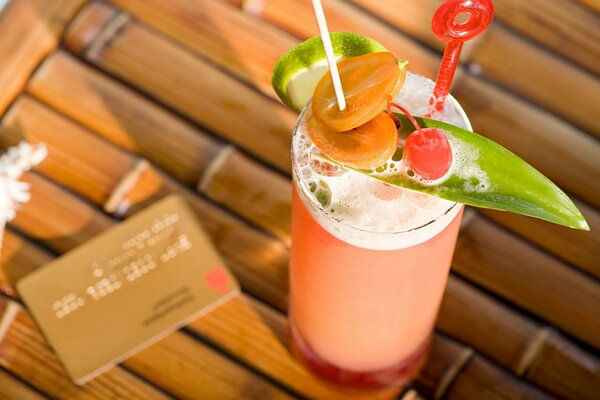 A cocktail glass on the table. Credit card